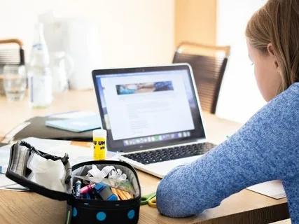 Teacher offering a virtual lesson through online tutoring jobs using a laptop and digital tools