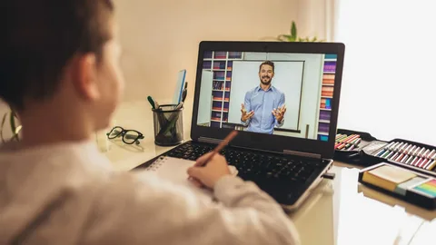 A teacher engaging with students during a live session, exemplifying the concept of teaching online.