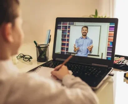 A teacher engaging with students during a live session, exemplifying the concept of teaching online.